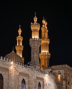 Illuminated Minarets of a Historic Egyptian Mosque at Night