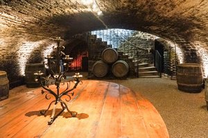 Historic Cellar with Rustic Wood Table and Stone Stairs