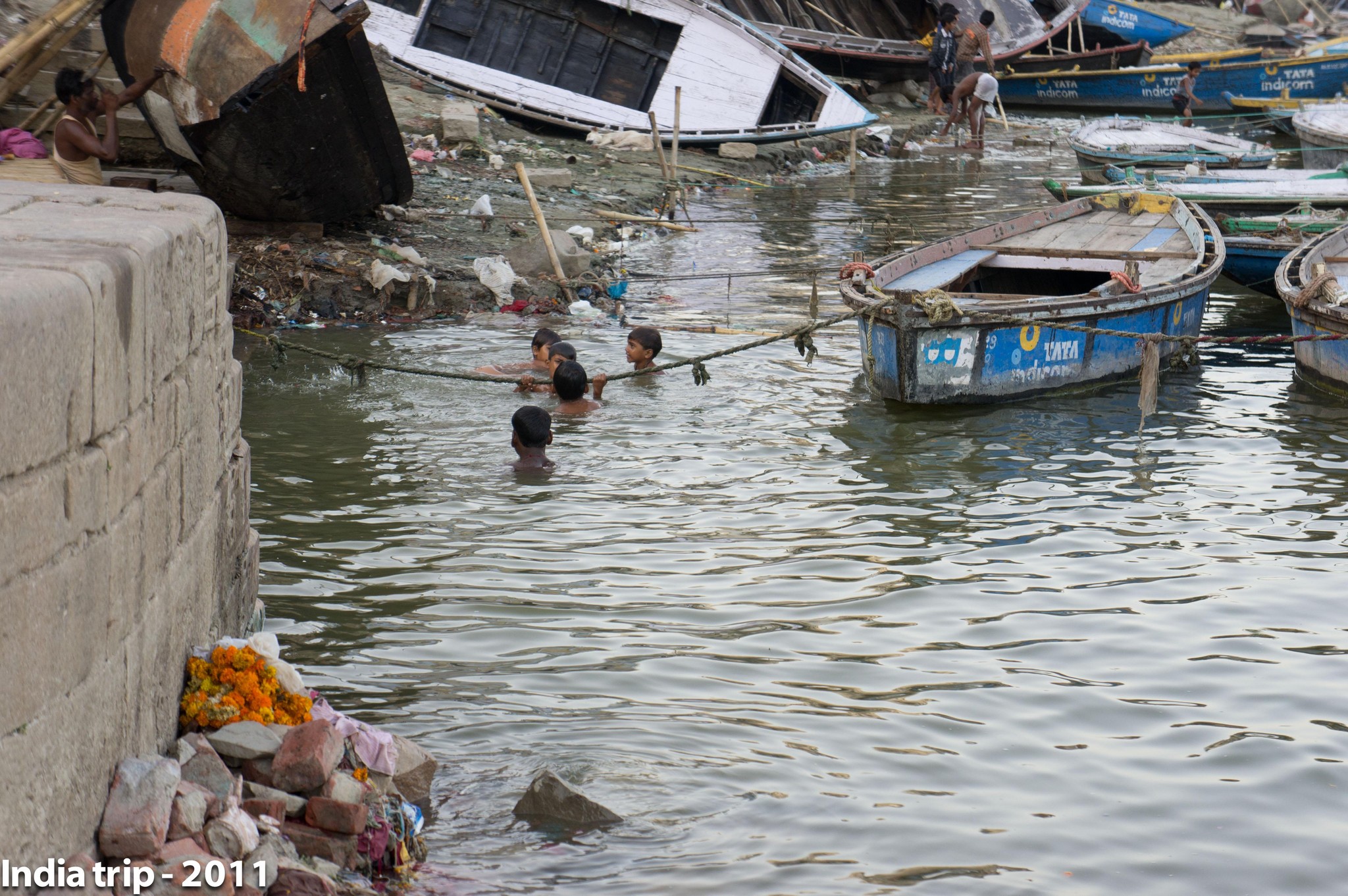 Children Swimming Amidst Dilapidated Boats in India