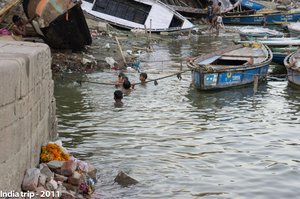 Children Swimming Amidst Dilapidated Boats in India