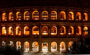 Illuminated Colosseum at Night: Ancient Rome's Golden Glow
