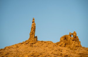 Jordanian Desert Spire: Ancient Rock Formations Against a Blue S