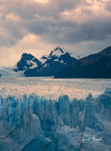 Patagonian Glacier's Azure Embrace Beneath Towering Peaks